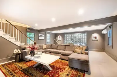a living room with a couch and a table at Exquisite Bedford Lux Retreat. in Bedford