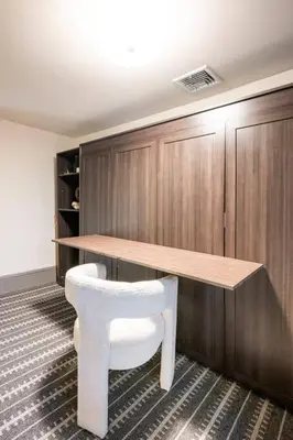 a table and a white chair in a room at Exquisite Bedford Lux Retreat. in Bedford