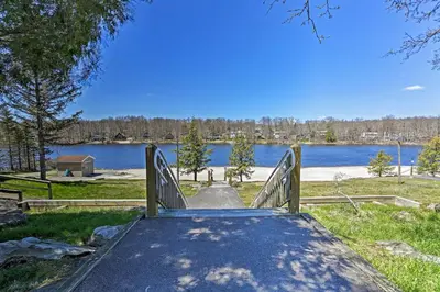 a wooden ramp with a view of a lake at 5 Mi to Tobyhanna State Park Home with Game Room! in Tobyhanna