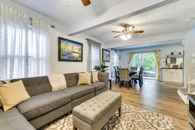 a living room with a couch and a table at 5 Mi to Tobyhanna State Park Home with Game Room! in Tobyhanna