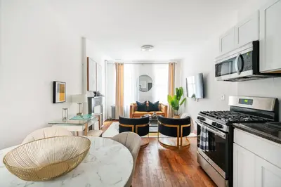 a living room with a kitchen and a dining room at 1288-3RN New Renovated 1 Bedroom in UES in New York