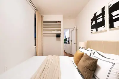 a bedroom with a large white bed with pillows at 1288-3RN New Renovated 1 Bedroom in UES in New York