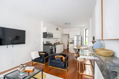 a kitchen and living room with a table and chairs at 1288-3RN New Renovated 1 Bedroom in UES in New York