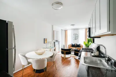 a kitchen with a table and chairs in a room at 1288-3RN New Renovated 1 Bedroom in UES in New York