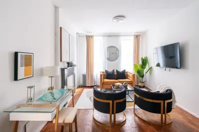 a living room with a glass table and chairs at 1288-3RN New Renovated 1 Bedroom in UES in New York