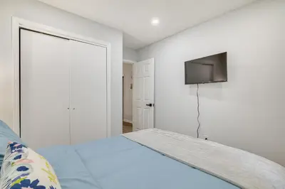 a bedroom with a bed with a tv on the wall at Community Perks Family Poconos Home with Deck! in Tobyhanna
