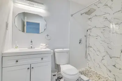 a white bathroom with a toilet and a shower at Community Perks Family Poconos Home with Deck! in Tobyhanna