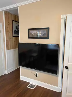 a large flat screen tv on a wall at Beautiful Studio Apartment in Historic House in New Haven