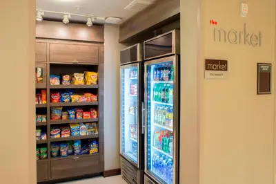 a refrigerator in a store with food and drinks at Residence Inn by Marriott Albany Clifton Park in Clifton Park