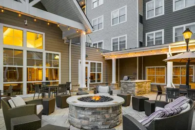 an outdoor patio with a fire pit and tables and chairs at Residence Inn by Marriott Albany Clifton Park in Clifton Park