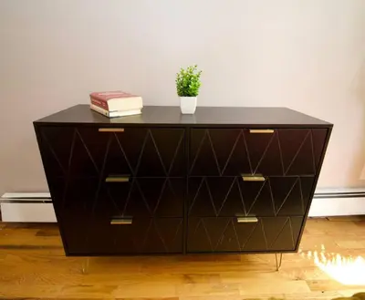 a black dresser with a plant on top of it at Tuk Ahoy - Sunset Suite 2B with Shared Spaces in Brooklyn