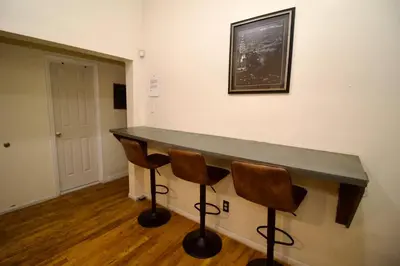 a counter in a room with two chairs at Tuk Ahoy - Sunset Suite 2B with Shared Spaces in Brooklyn