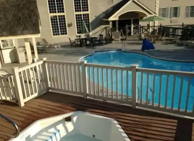a deck with a swimming pool on a house at 1st Floor Mountain View Suite Ski On Off At Jiminy- Fully Redone Decor in Hancock