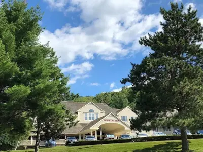 a house with trees in front of it at 1st Floor Mountain View Suite Ski On Off At Jiminy- Fully Redone Decor in Hancock