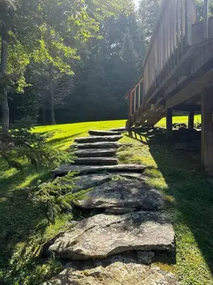 a stone path next to a building with a bench at Campbell Estates in Franklin