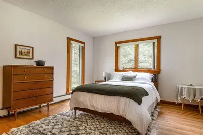a bedroom with a bed and a dresser and windows at Campbell Estates in Franklin