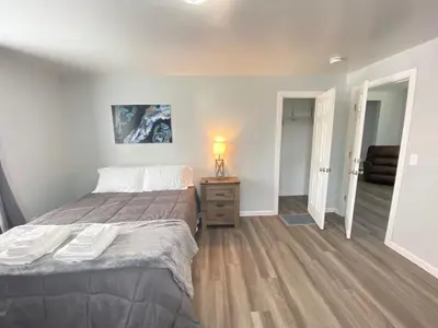 a bedroom with a bed and a lamp on a night stand at 3rd Base Apt 1 All Star Baseball Rentals in Oneonta