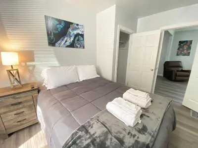 a bedroom with a large bed with towels on it at 3rd Base Apt 1 All Star Baseball Rentals in Oneonta
