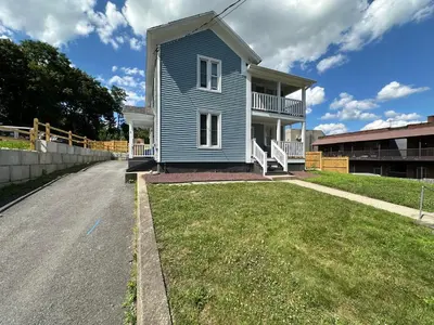 a blue house on the side of a road at 3rd Base Apt 2 All Star Baseball Rentals in Oneonta