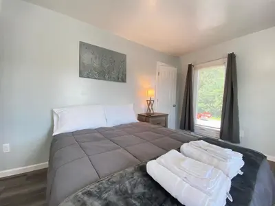 a bedroom with a large bed and a window at 3rd Base Apt 2 All Star Baseball Rentals in Oneonta