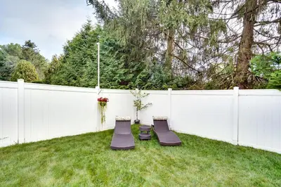two chairs in a backyard with a white fence at Cozy Albany Vacation Rental about 5 Mi to Downtown! in Albany
