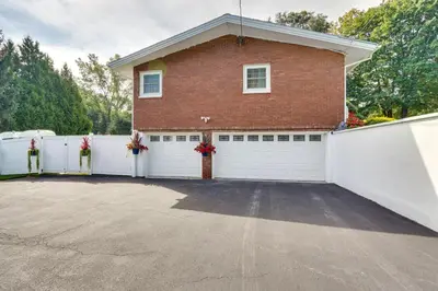 a house with a white fence and a garage at Cozy Albany Vacation Rental about 5 Mi to Downtown! in Albany