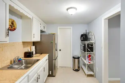 a kitchen with a sink and a refrigerator at Cozy Albany Vacation Rental about 5 Mi to Downtown! in Albany