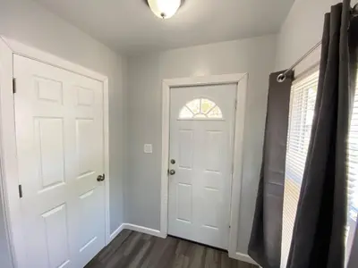 a hallway with a white door and a window at Double Play Apt 1 All Star Baseball Rentals in Oneonta
