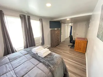 a bedroom with a bed and a desk with a computer at Double Play Apt 1 All Star Baseball Rentals in Oneonta
