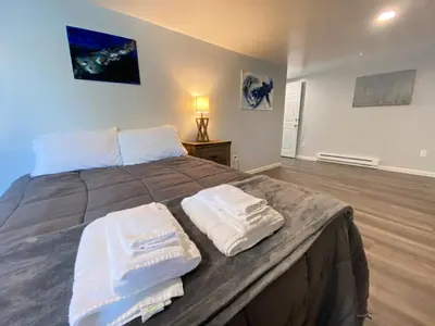 a bedroom with a bed with two towels on it at Double Play Apt 1 All Star Baseball Rentals in Oneonta
