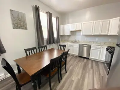 a kitchen with a wooden table and chairs in a room at Double Play Apt 1 All Star Baseball Rentals in Oneonta