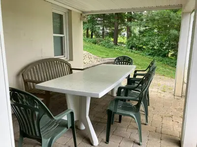 a white table and chairs on a patio at Fun on the Lake in East Hampton