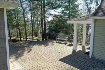 a pavilion with a bench on a patio at Fun on the Lake in East Hampton