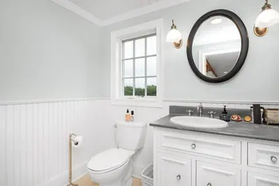 a white bathroom with a toilet and a sink at Lakeview Expanse in Bethlehem