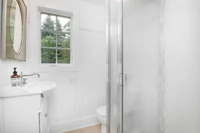 a white bathroom with a toilet and a sink at Lakeview Expanse in Bethlehem