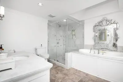 a white bathroom with a tub and a toilet and a sink at Lakeview Expanse in Bethlehem