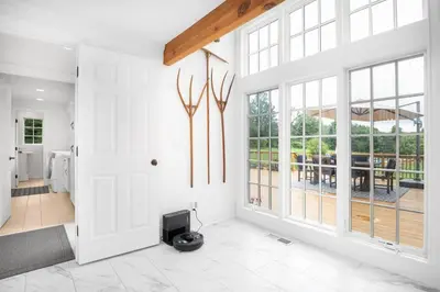 a living room with white walls and large windows at Lakeview Expanse in Bethlehem