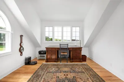 an attic office with a desk and a window at Lakeview Expanse in Bethlehem