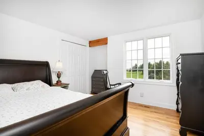a white bedroom with a bed and a window at Lakeview Expanse in Bethlehem