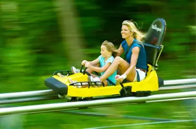 a woman and a child riding on a toy motorcycle at Must See Pirate Suite Ski On Off Jiminy - Mtn View Fully Redone Decor in Hancock
