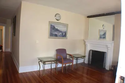 a room with two chairs and a table and a fireplace at West End Haven in Hartford