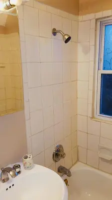 a bathroom with a white tub and a sink at West End Haven in Hartford