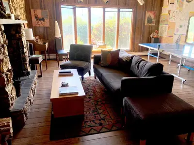 a living room with a couch and a table at Daydream Mountain Art Chateau in Catskill