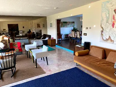 a living room with a couch and tables and chairs at Daydream Mountain Art Chateau in Catskill