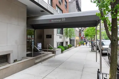 a building with a sign on the side of a sidewalk at Kips Bay 1br w gym nr empire state building NYC-1214 in New York