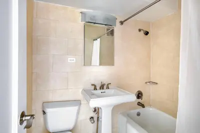 a bathroom with a sink and a toilet and a bath tub at Kips Bay 1br w gym nr empire state building NYC-1214 in New York