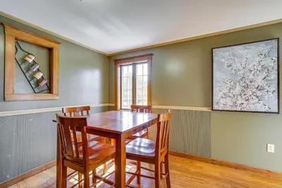 a dining room with a wooden table and chairs at Buskirk Vacation Rental with Deck and Putting Green! in Buskirk