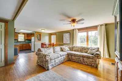 a living room with a couch and a kitchen at Buskirk Vacation Rental with Deck and Putting Green! in Buskirk