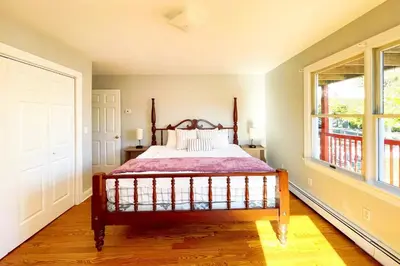 a bedroom with a bed and a large window at Modern Home off I-95 Perfect for Families & Business Stay with Ample Parking in Stamford
