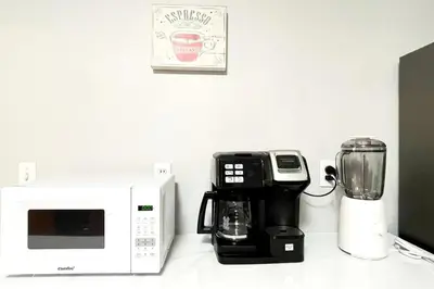 a kitchen counter with a coffee maker and a microwave at Modern Home off I-95 Perfect for Families & Business Stay with Ample Parking in Stamford